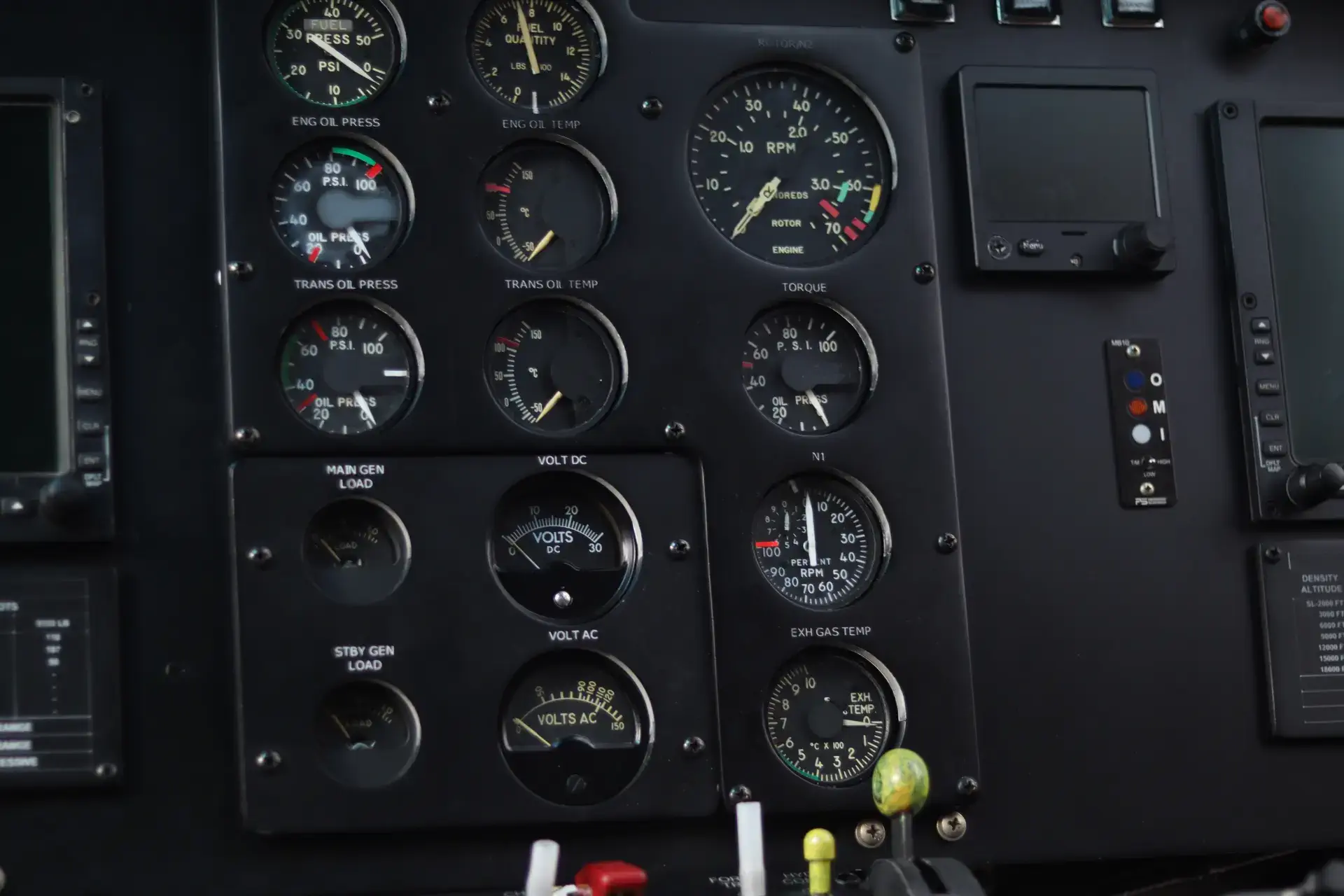 Close-up of an aircraft's instrument panel with various gauges, including fuel, oil pressure, and voltage.