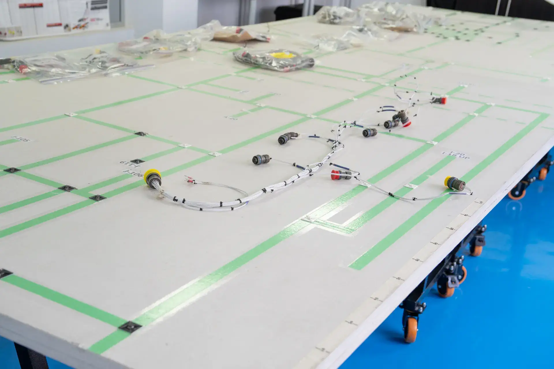 Schematic layout of wires and electronic components on a large labeled grid table.